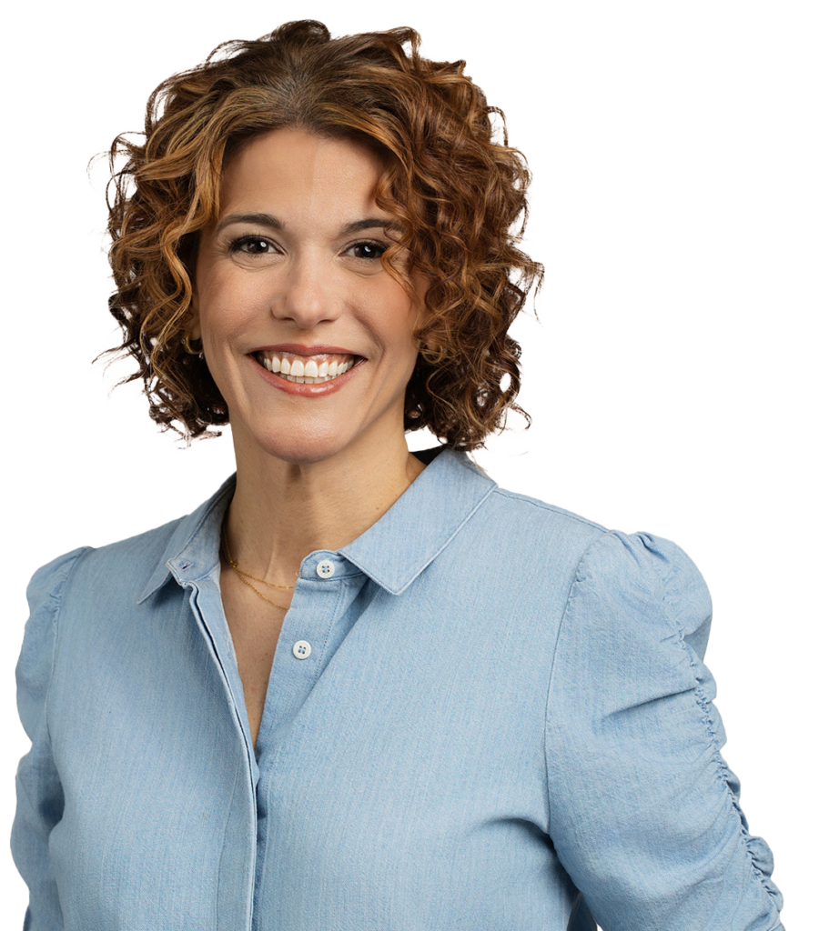 Smiling woman with curly hair wearing a light blue blouse against a plain background, showcasing a high-quality headshot perfect for capturing her new career move.